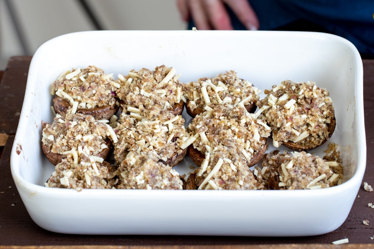 stuffed mushrooms in a white casserole dish