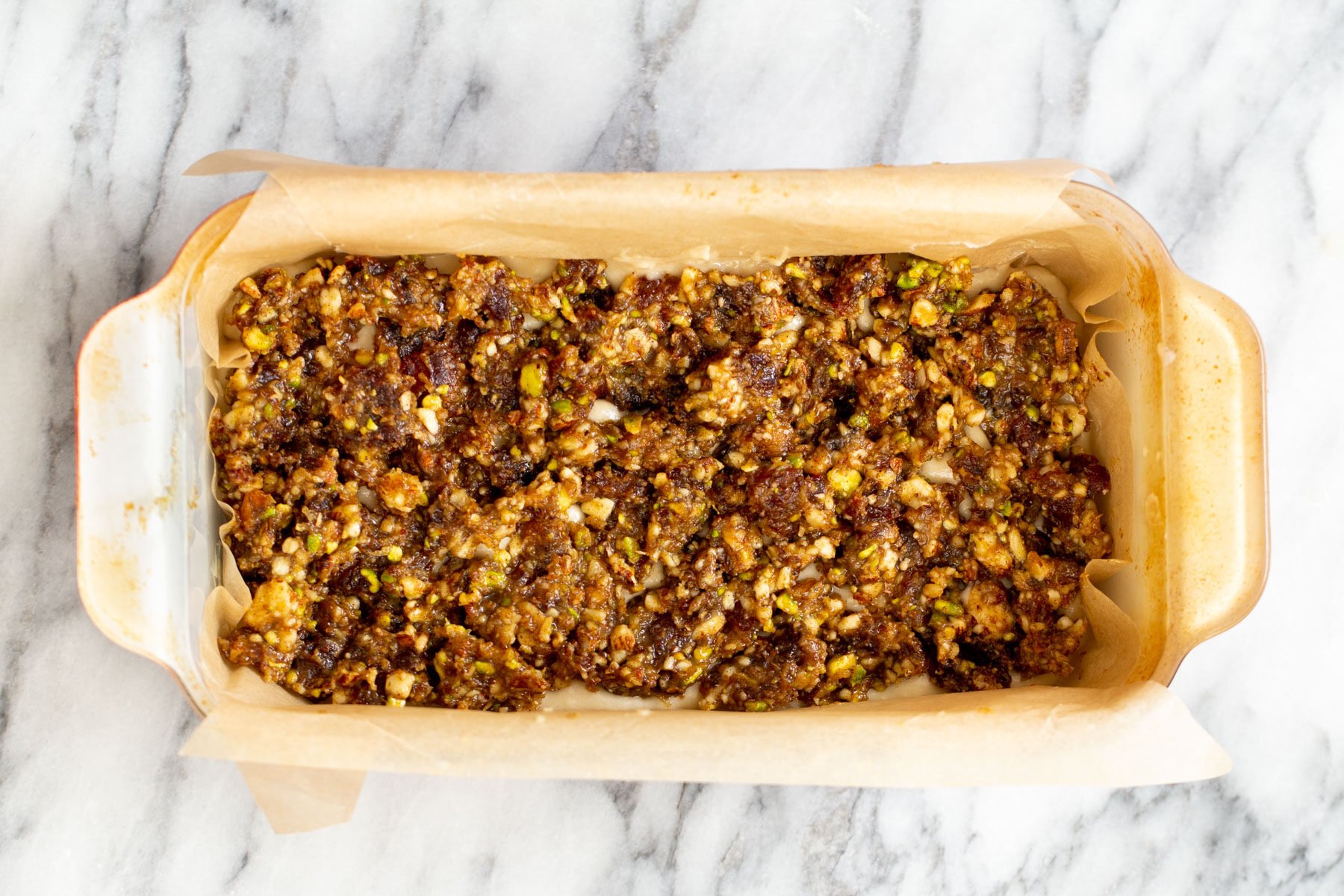 nut and date mixture spread on cake batter