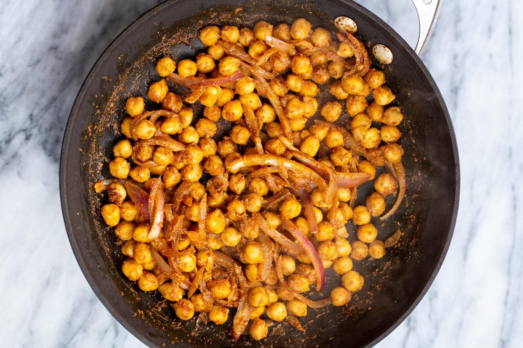 berbere spiced chickpeas in a sauteeing pan