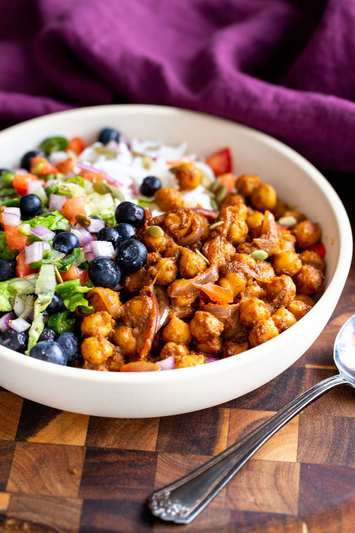 Ethiopian chickpea bowls served with rice and blueberry tomato salad