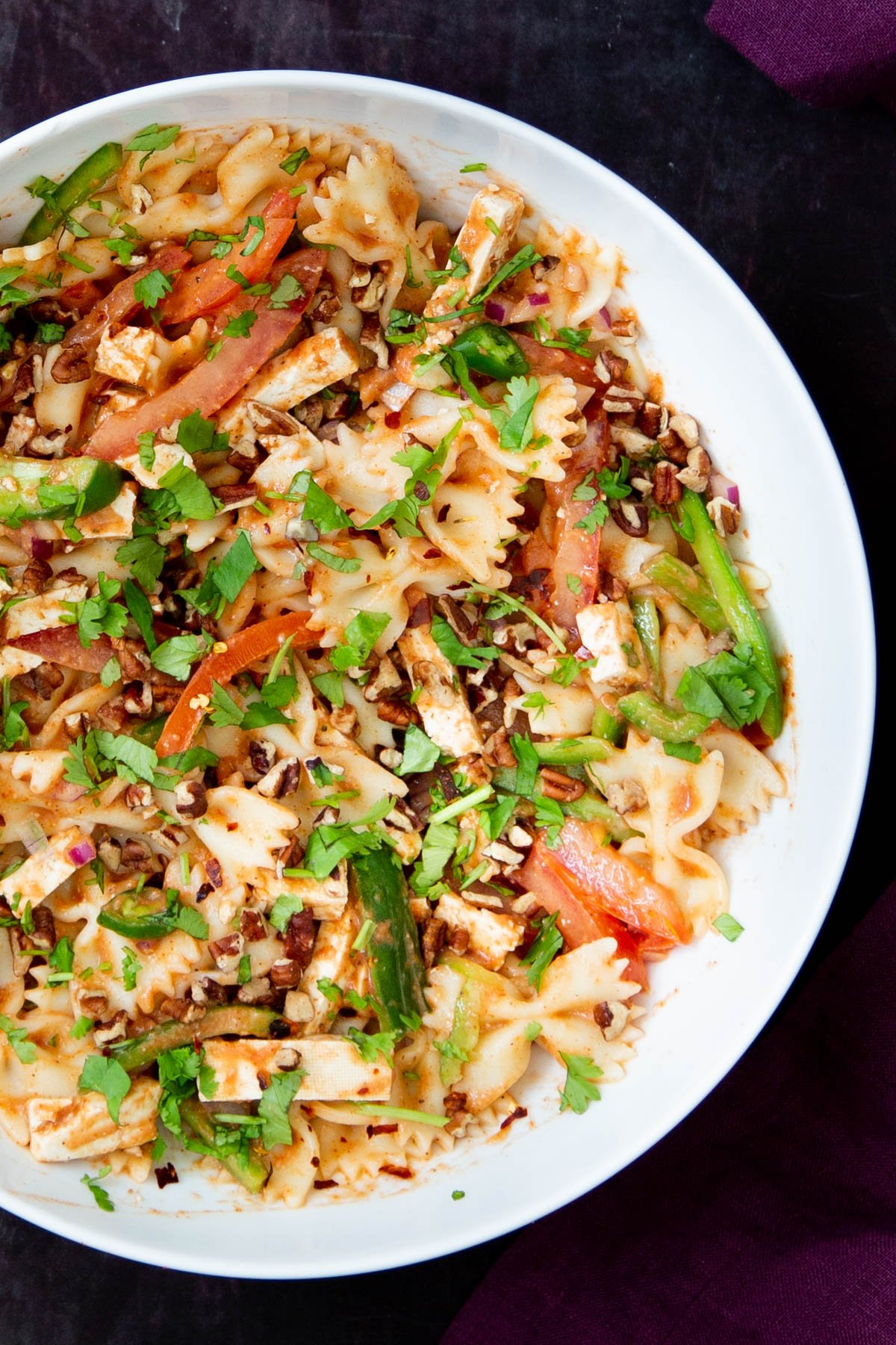 creamy vegan Indian Tikka Masala pasta salad with veggies in a white bowl