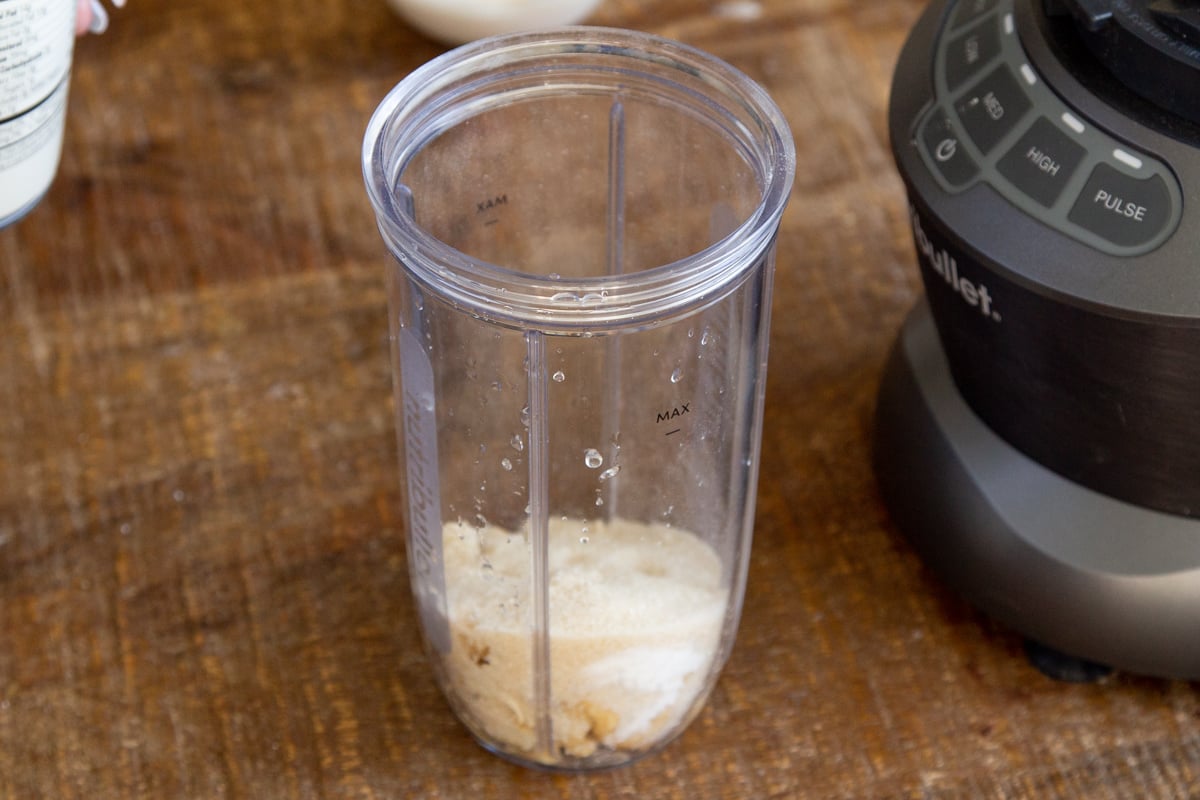 ingredients for vegan cashew mascarpone cream in a nutri bullet