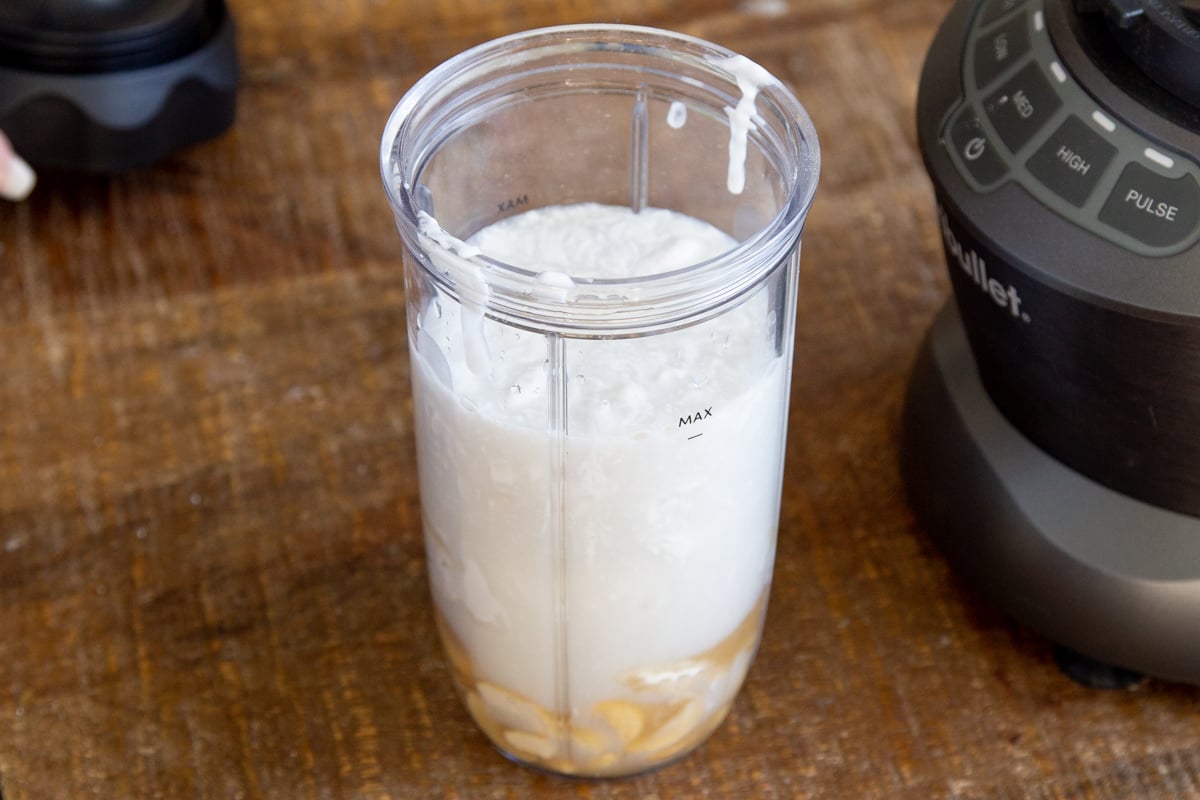 ingredients for making vegan mascarpone cream in the container of a small blender