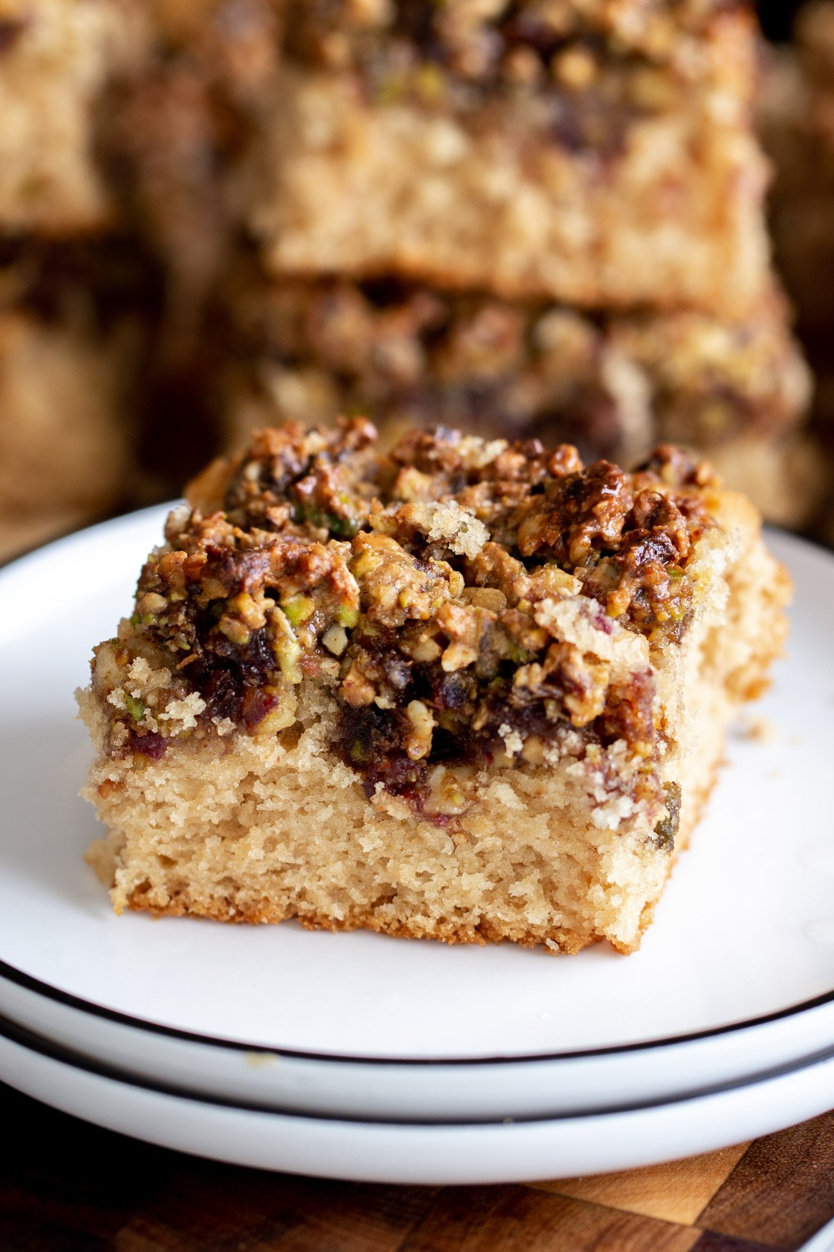 a slice of vegan baklava cake on a white cake plate