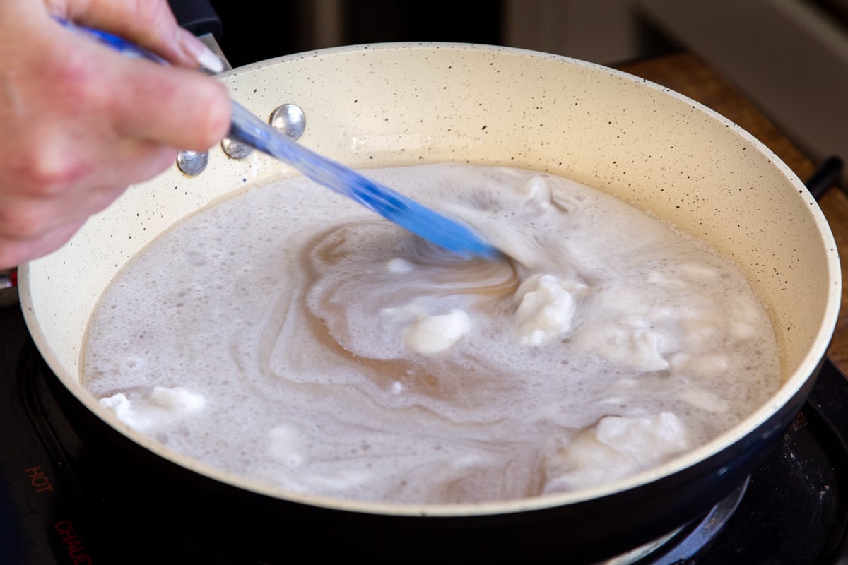 coconut milk in a sauteeing pan