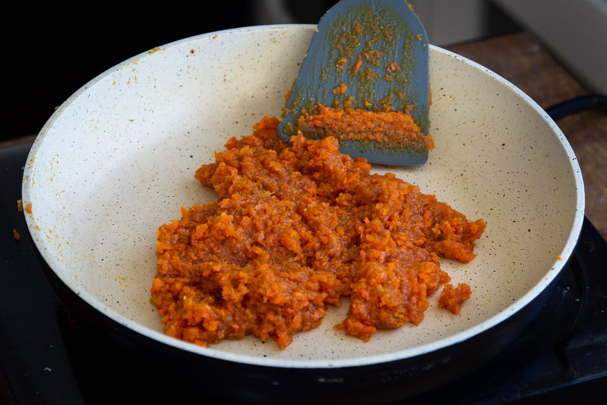 shredded caramelized carrots in a frying pan