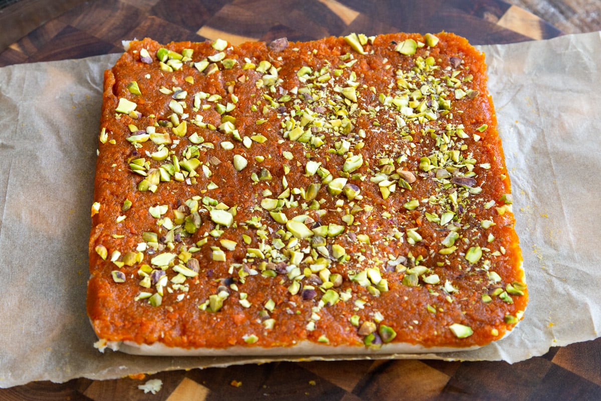 coconut burfi carrot halwa bars topped with pistachios