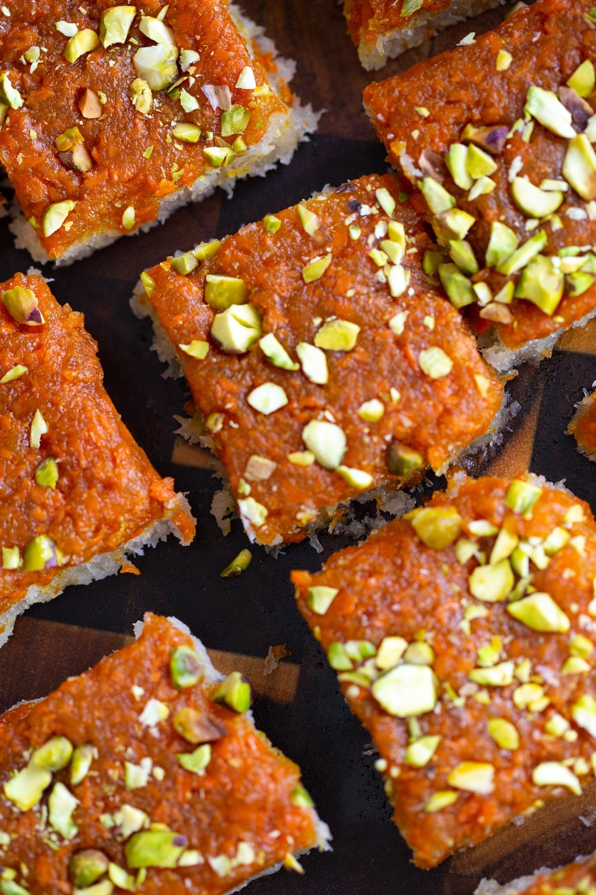carrot halwa coconut burfi bars topped with chopped pistachios