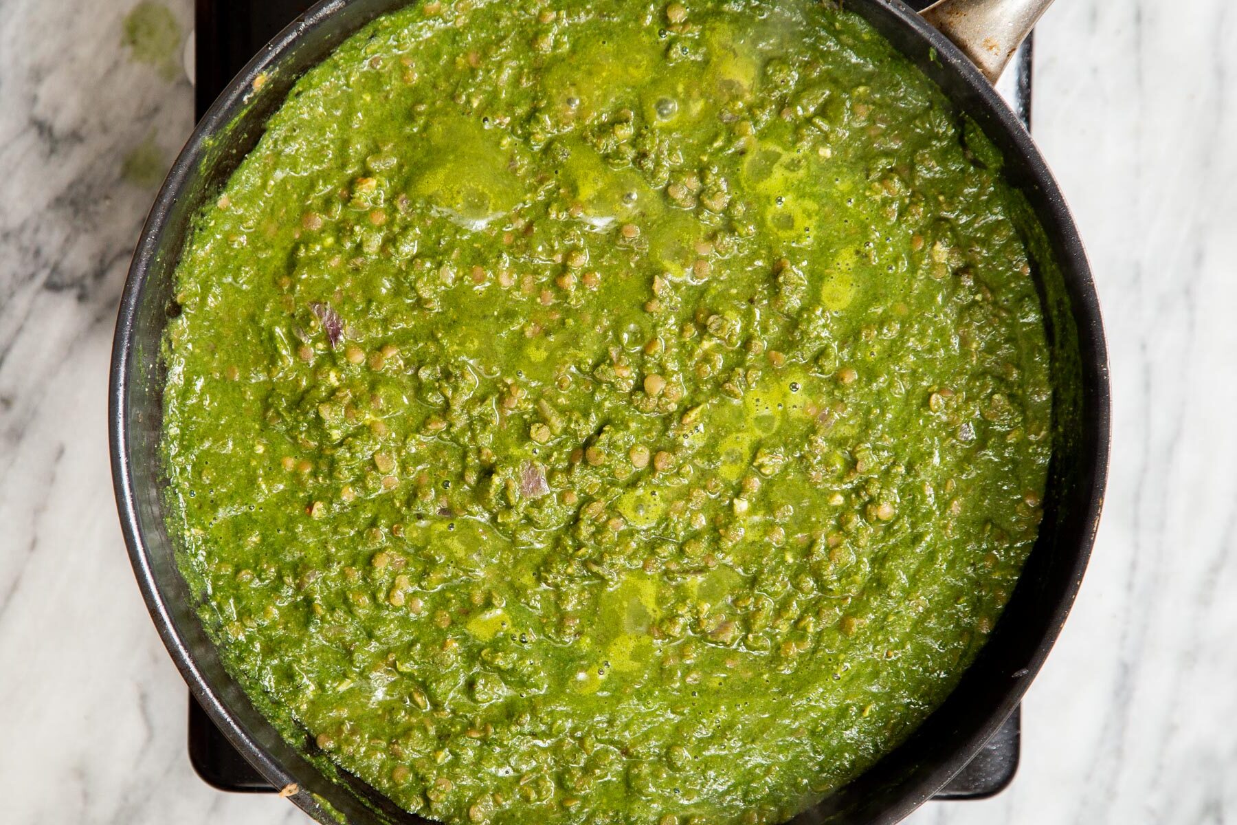 vegan green keema with lentils in a black skillet