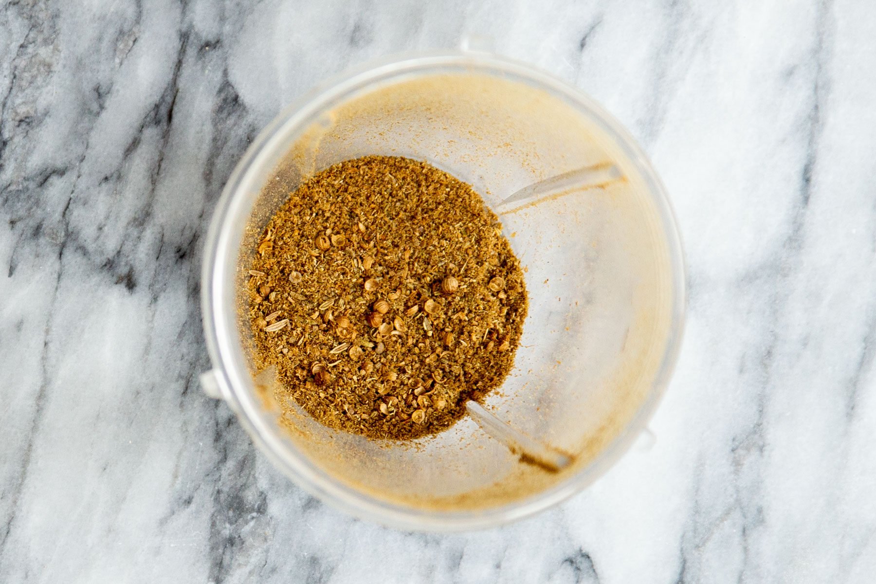 ground coriander and fennel seeds in a grinder