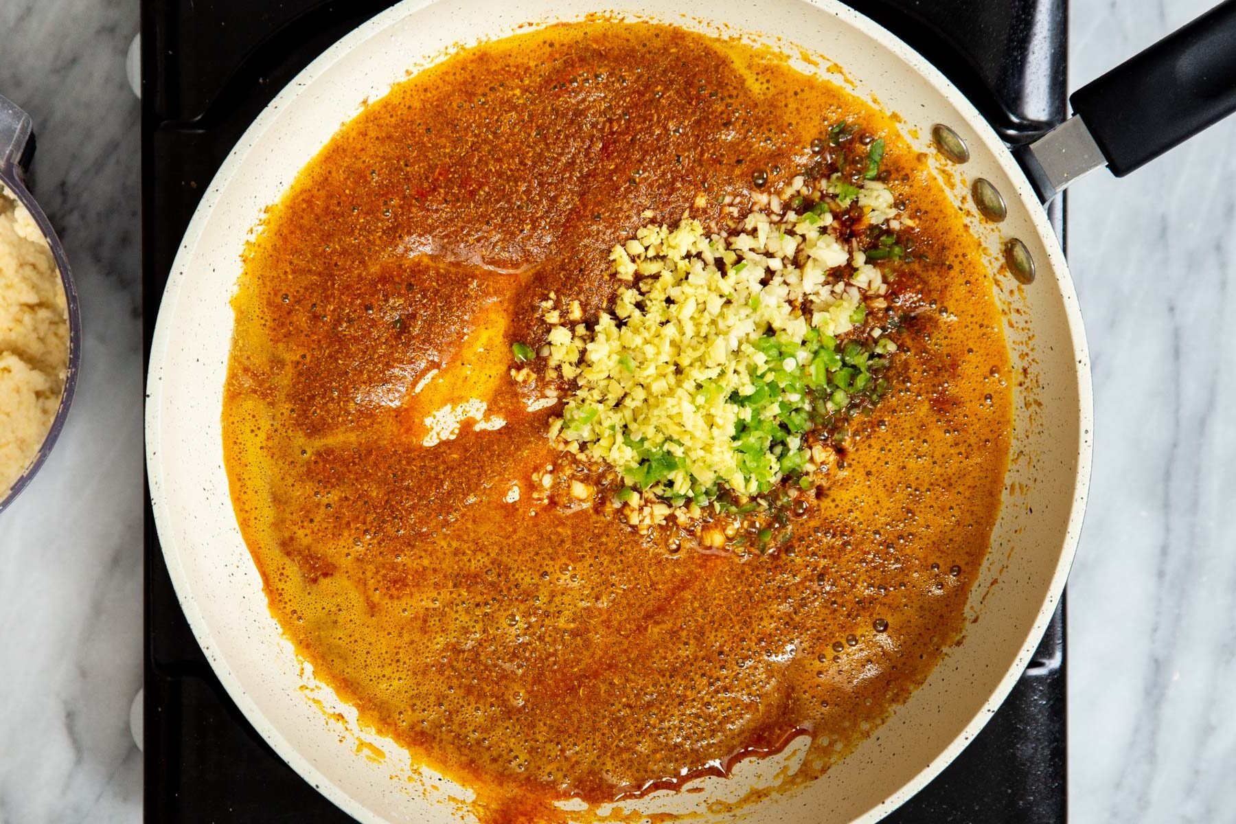 spices, garlic, chili and ginger frying in a sauteeing pan