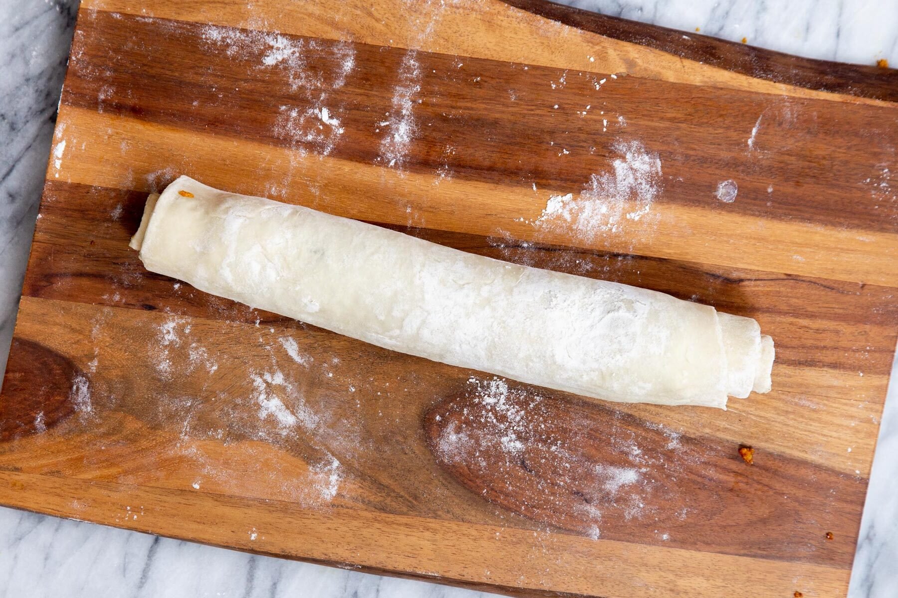 rolled up filled puff pastry ready for cutting into pinwheels
