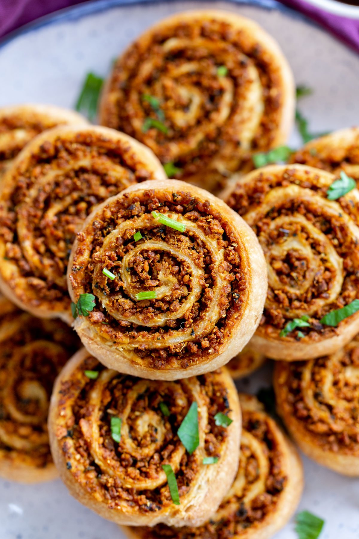 close up of a platter of puff pastry pinwheels with lentil filling