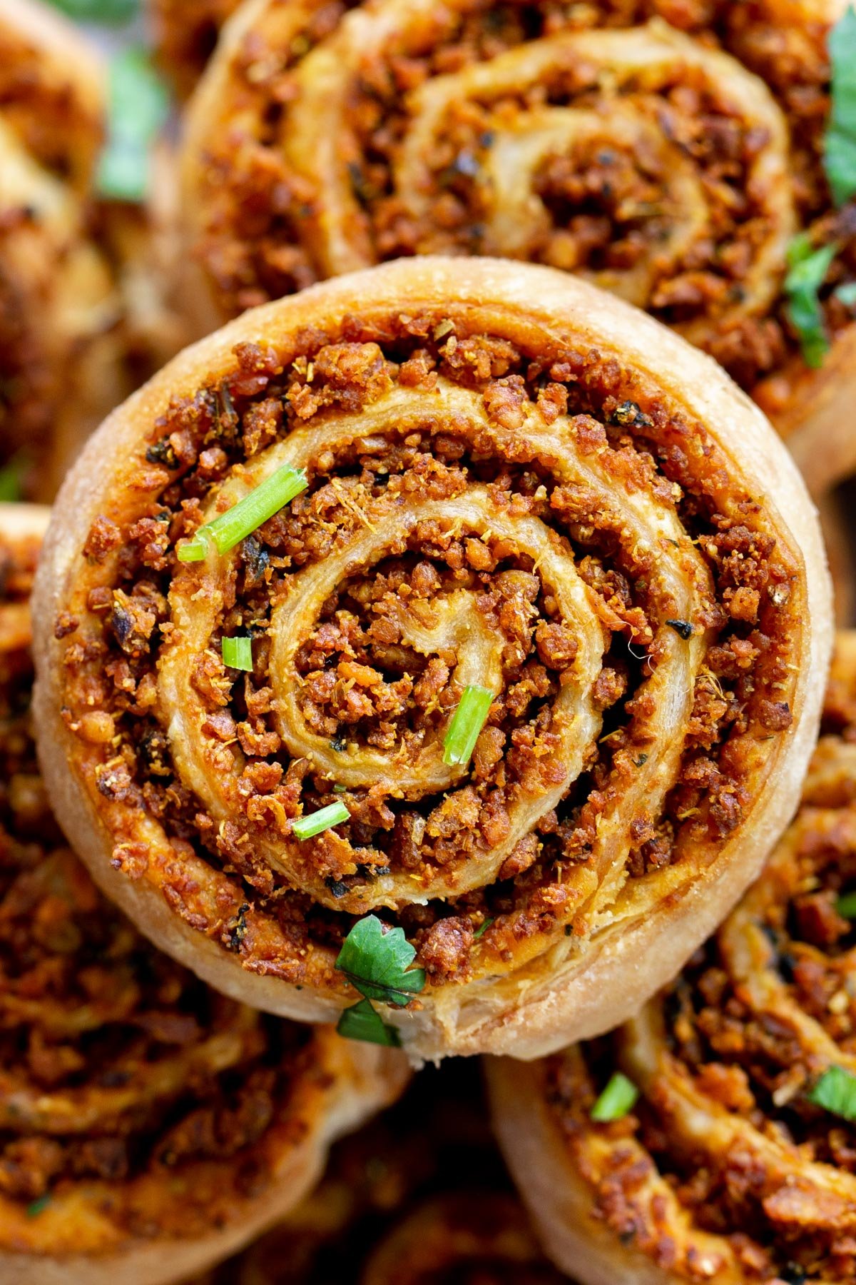 close up of a platter of puff pastry pinwheels with lentil filling