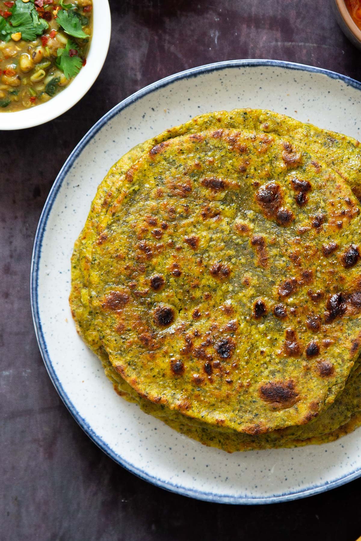 Indian masala flatbreads stacked on a white plate