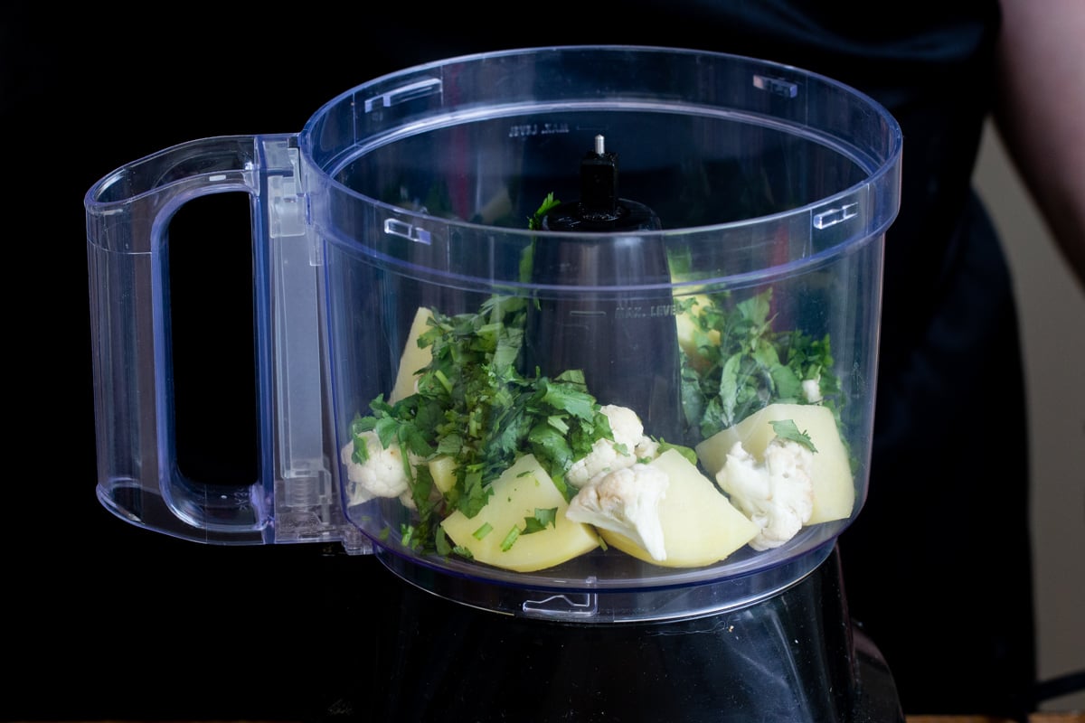 veggies in the container of a food processor