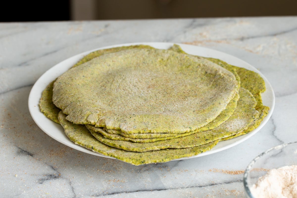 rolled out masala parathas on a white plate