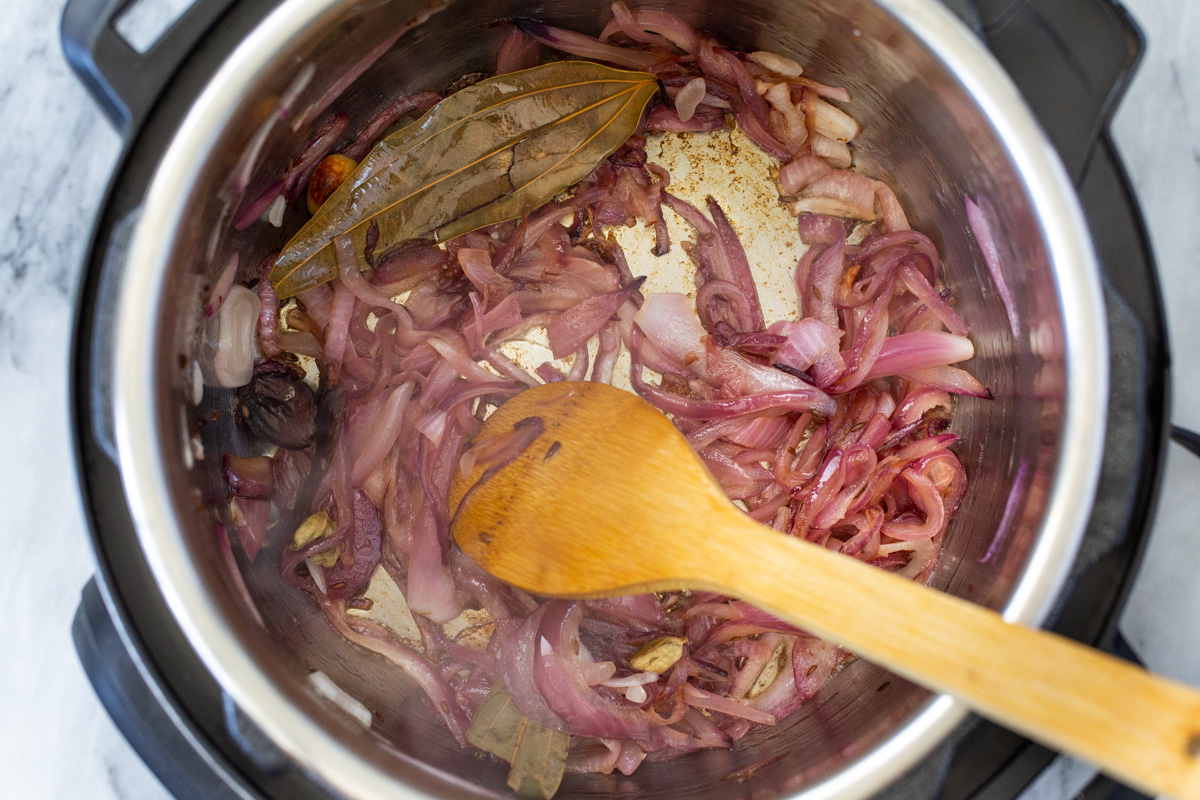onions and spices sauteeing in an Instant Pot