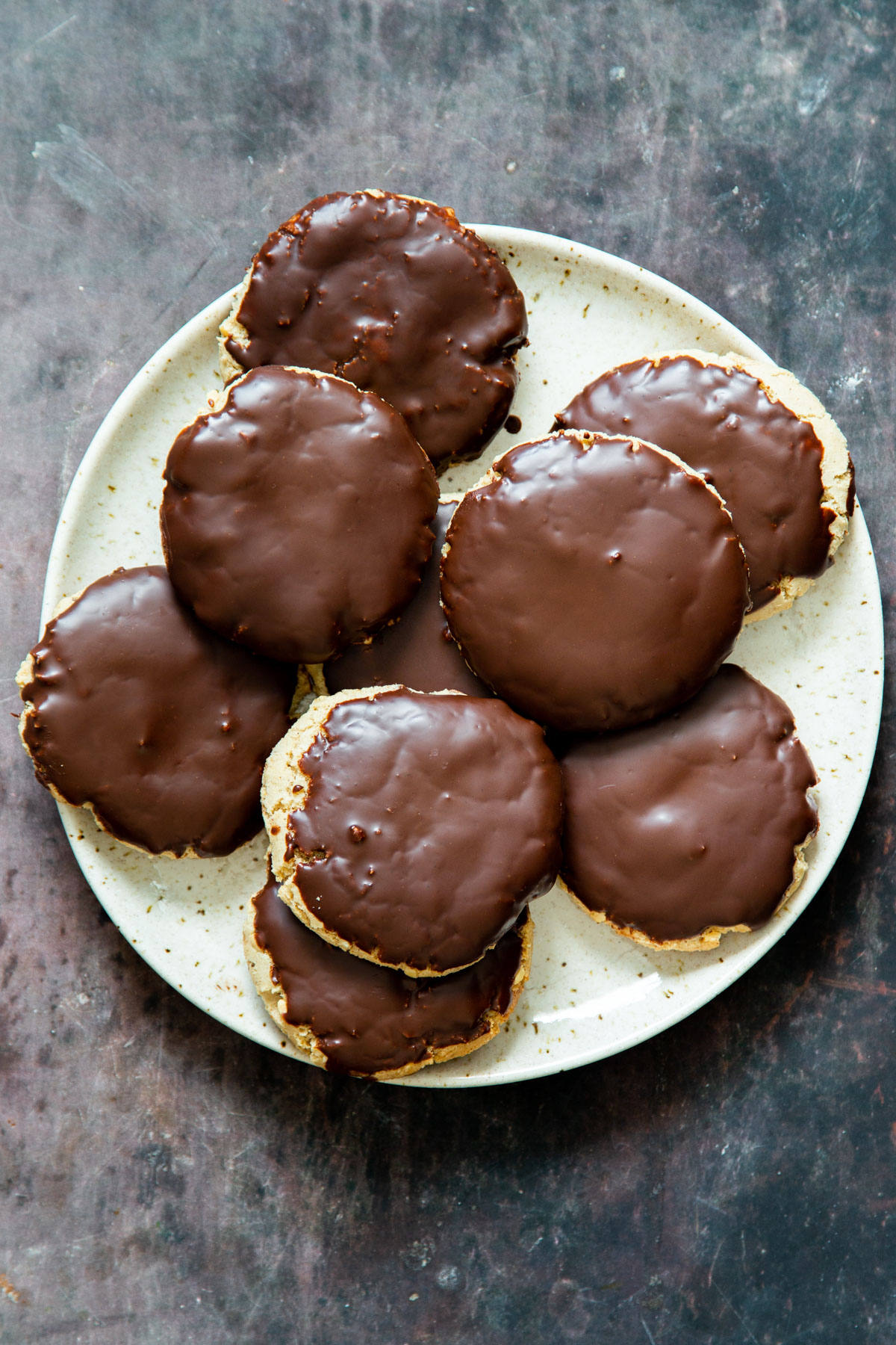 a plate of vegan snickers cookies covered with chocolate glaze