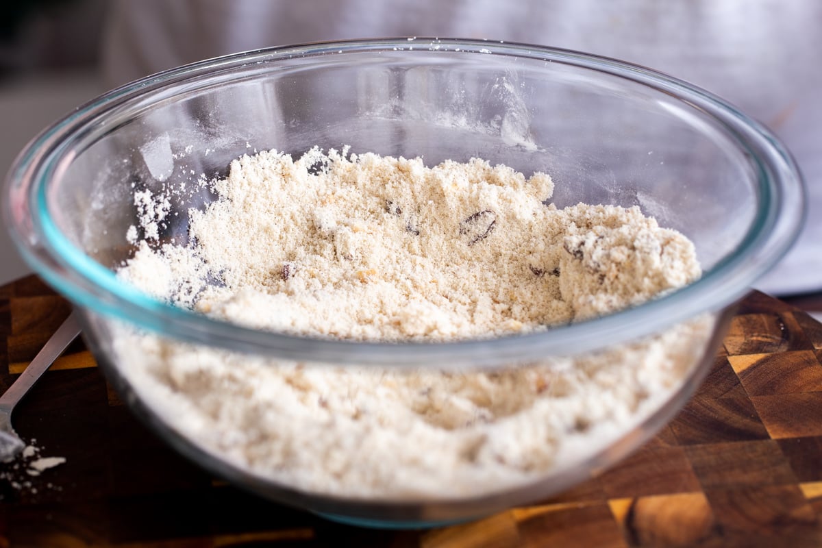 dry mix for vegan snickers cookies in a glass mixing bowl