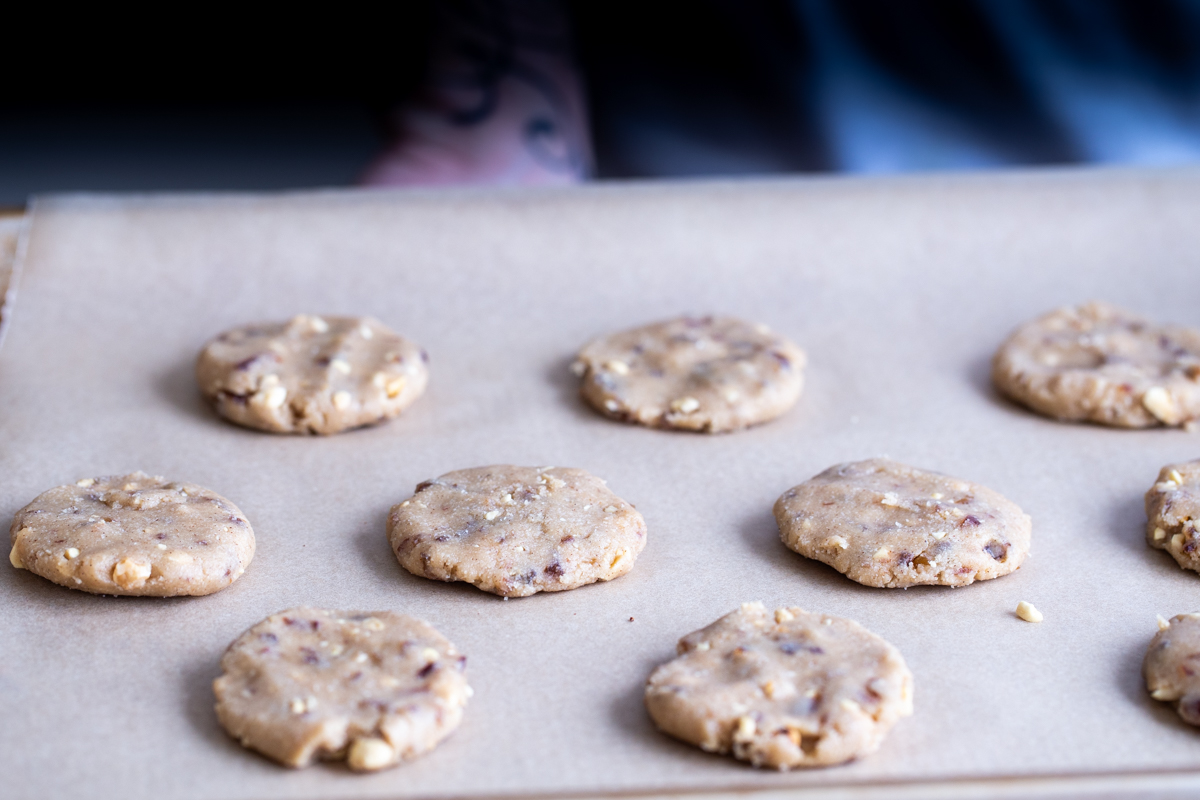 unbaked vegan snickers cookies on a cookie sheet