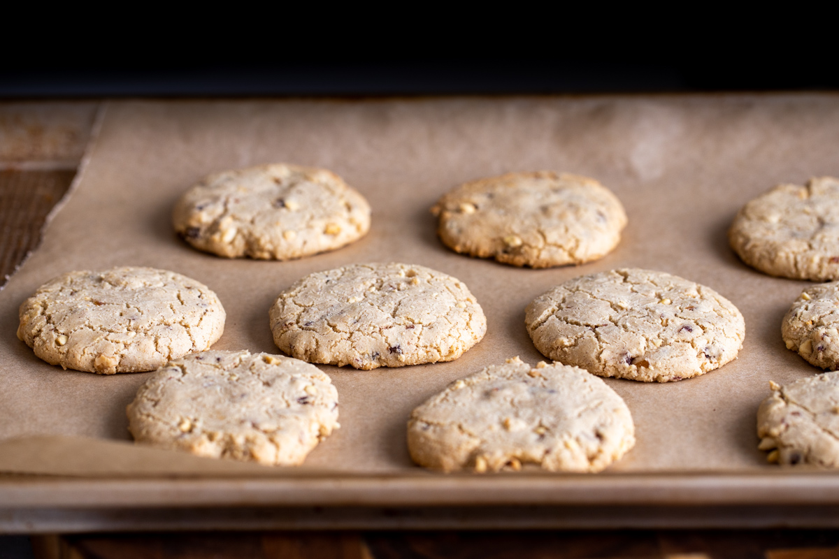 freshly baked vegan snickers cookies baking on a cookie tray