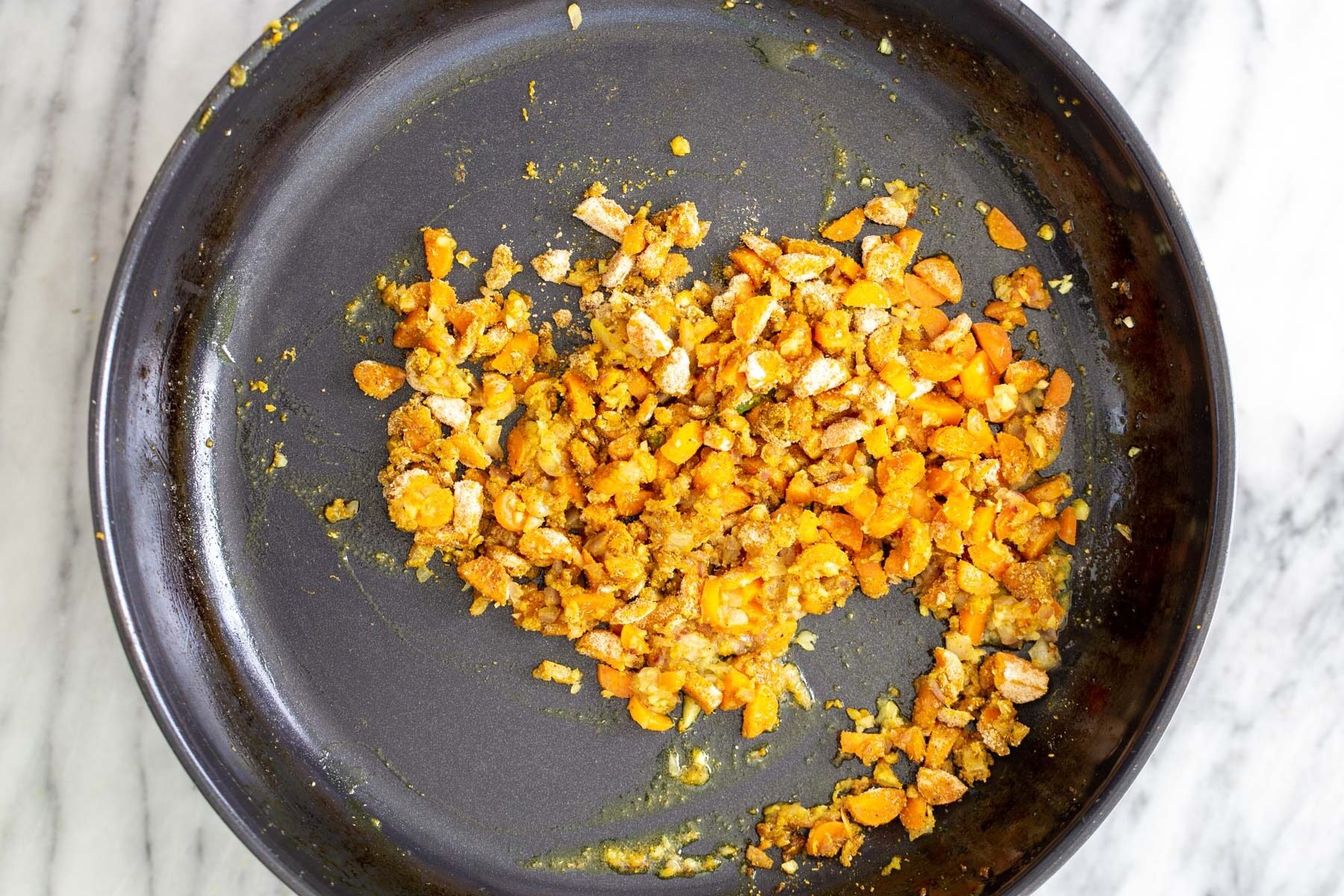 chopped sauteed veggies and garlic in a skillet