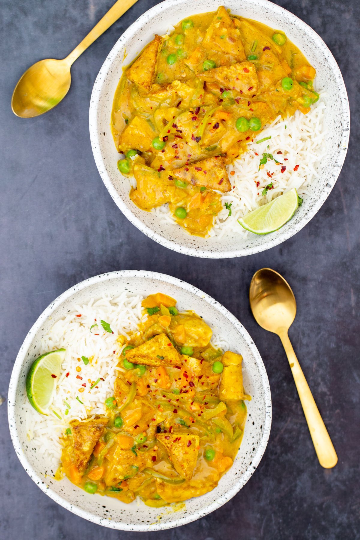 two bowls with Malaysian tofu curry served with rice