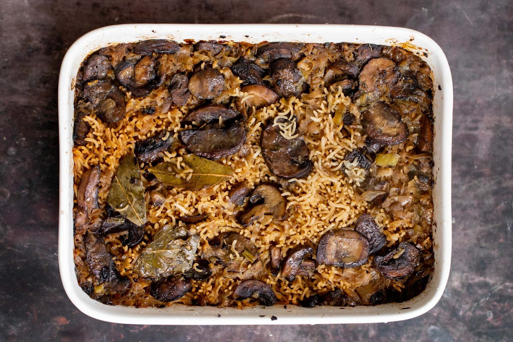 a casserole dish with baked mushroom rice