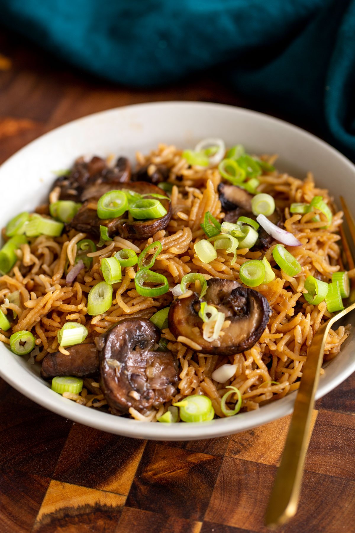 a plate with baked mushroom rice topped with sliced green onions