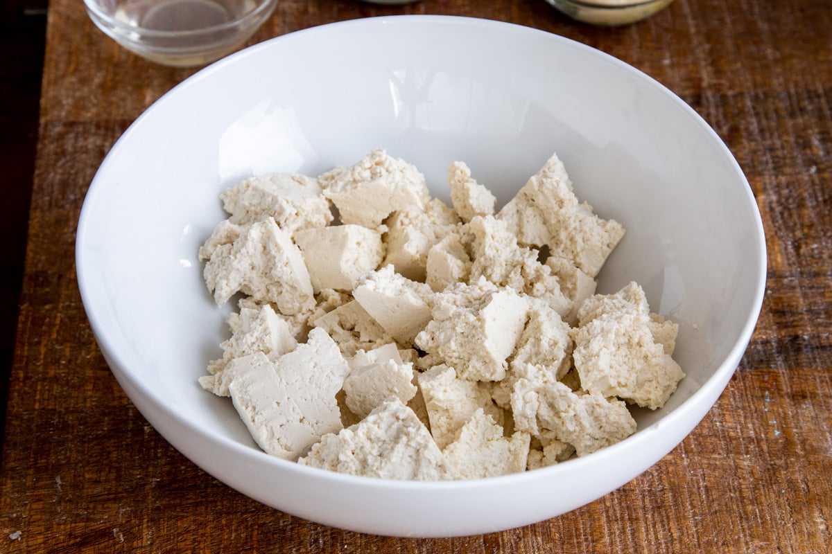 torn up tofu in a white bowl