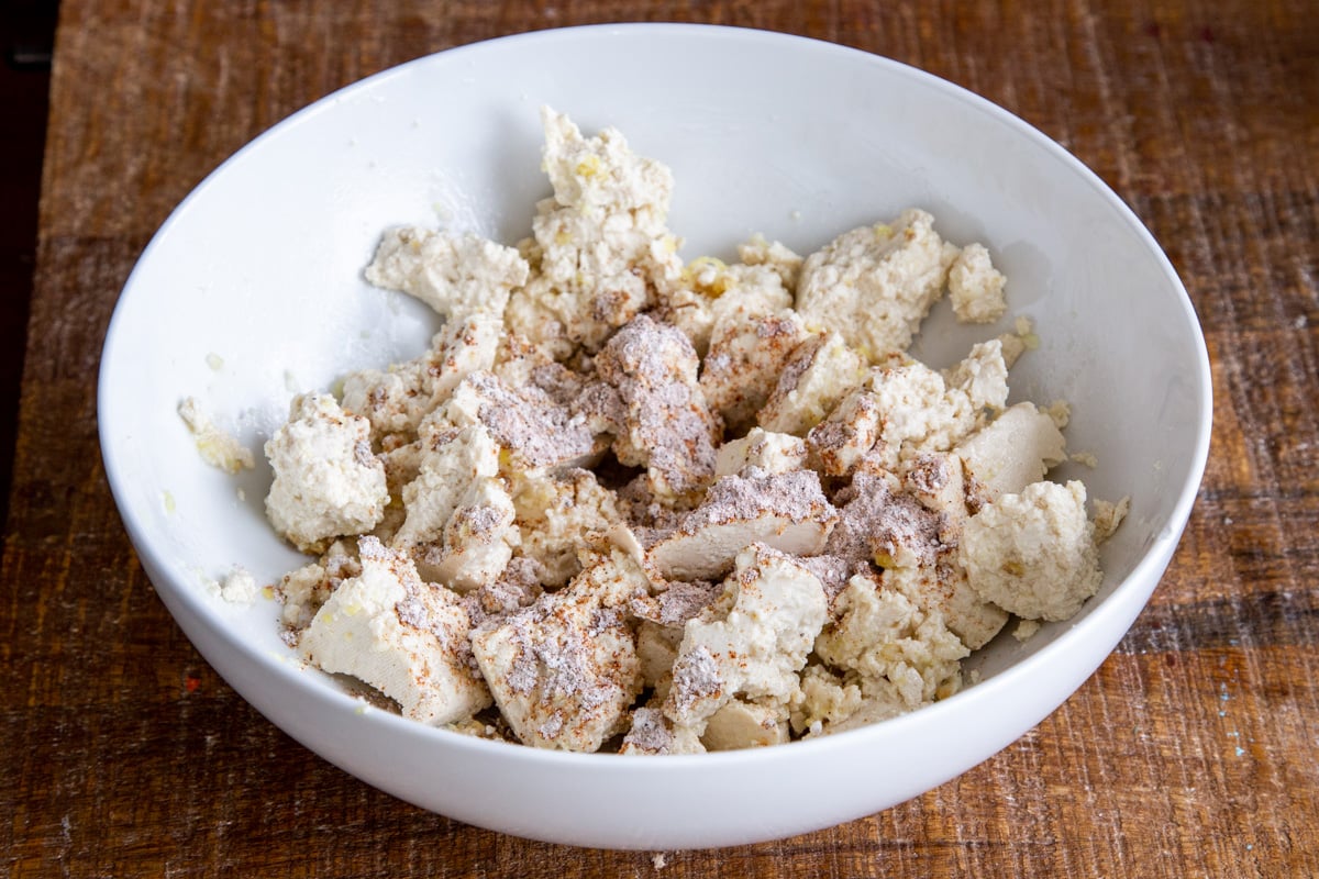 torn up tofu sprinkled with cornstarch and spice mix