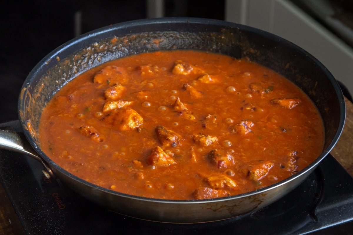 vegan chicken changezi simmering in a black frying pan
