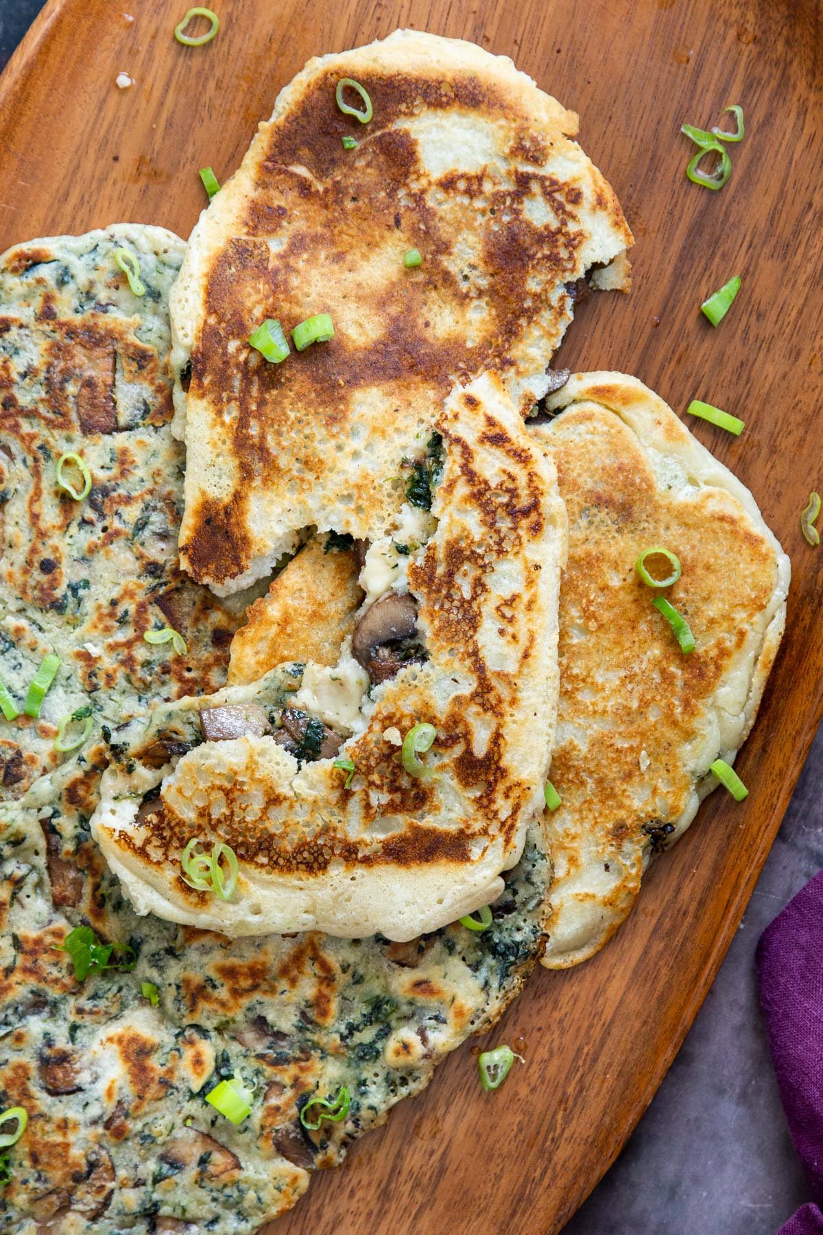 vegan glutenfree spinach and mushroom stuffed naan bread sprinkled with sliced green onions