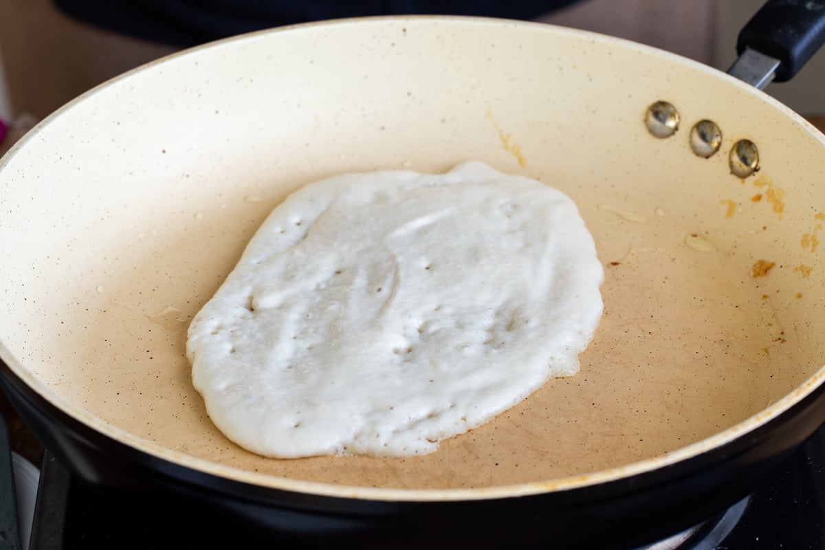 glutenfree almond flour naan batter being spread into a pan