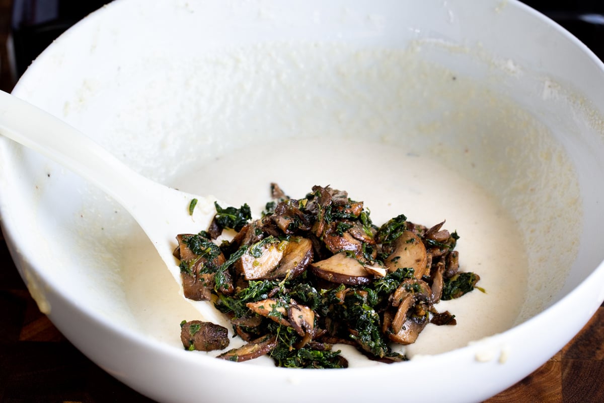 spinach mushroom mix being added to vegan naan batter