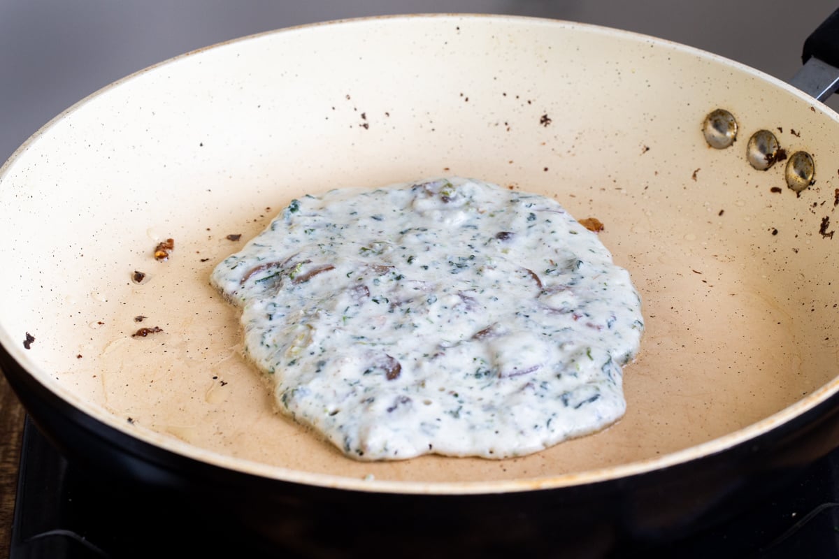 vegan spinach mushroom naan baking in a pan