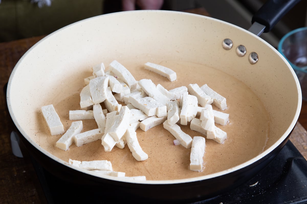 tofu being fried in a pan