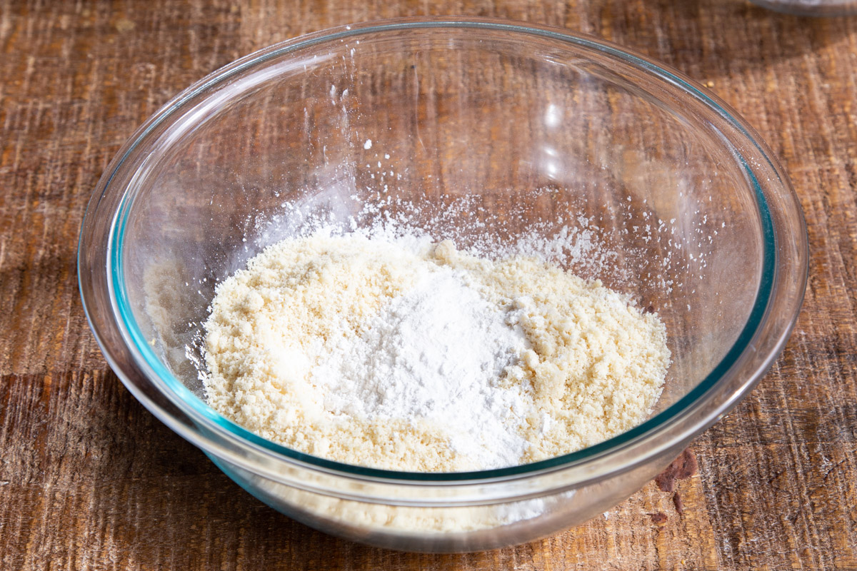 dry ingredients for almond flour chocolate chunk cookies in a glass bowl