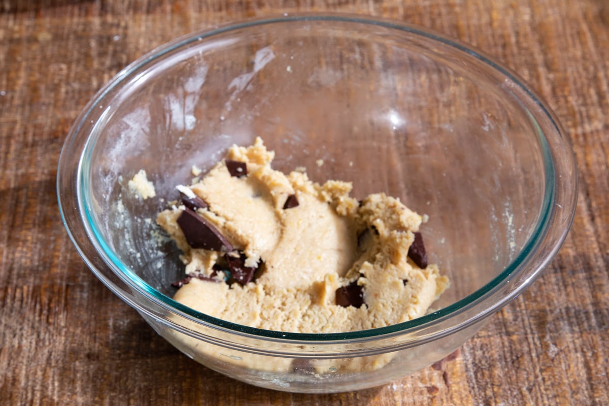 almond flour chocolate chip cookie dough with chocolate chunks in a glass bowl