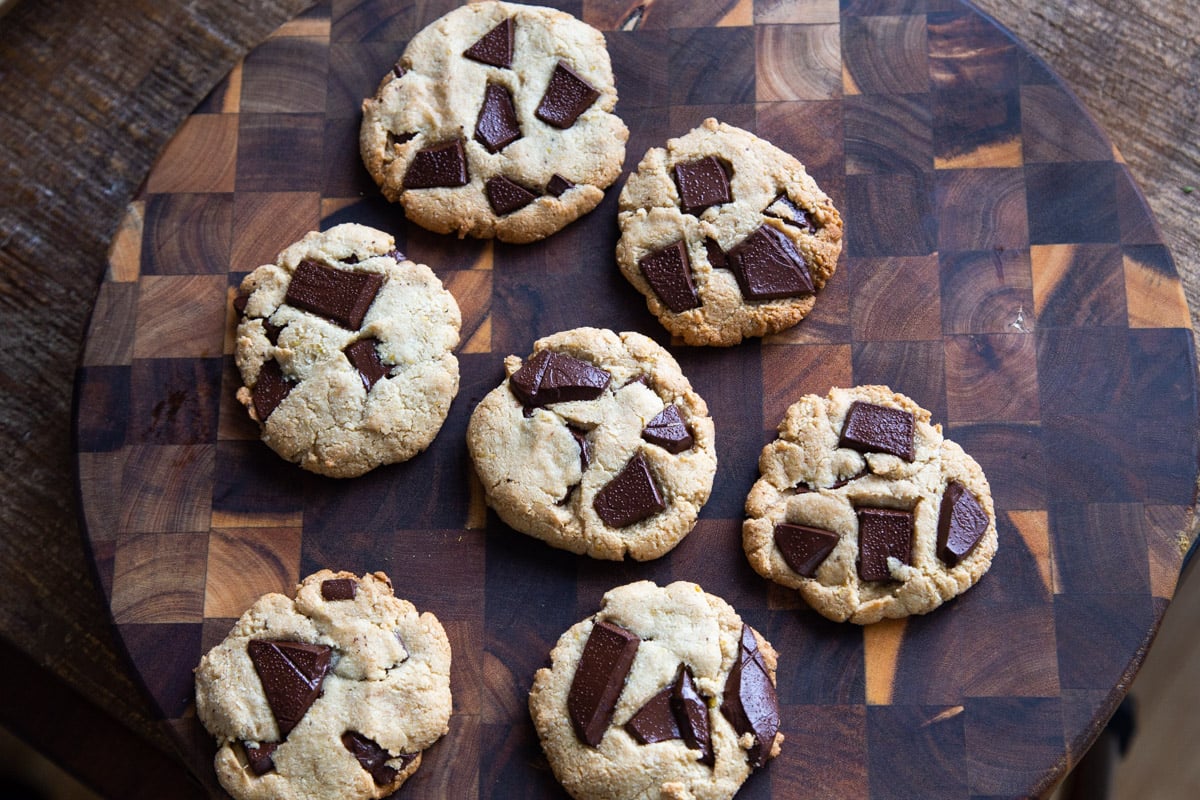 freshly baked miso chocolate chunk cookies on a wooden chopping board