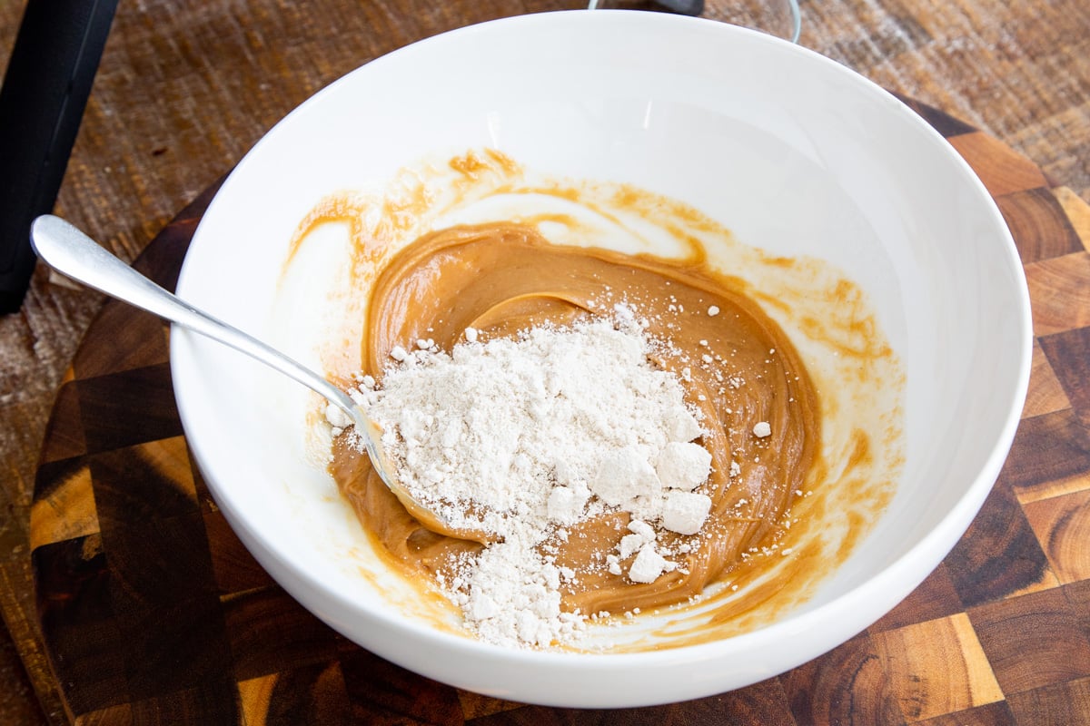 glutenfree flour being stirred into the peanut butter