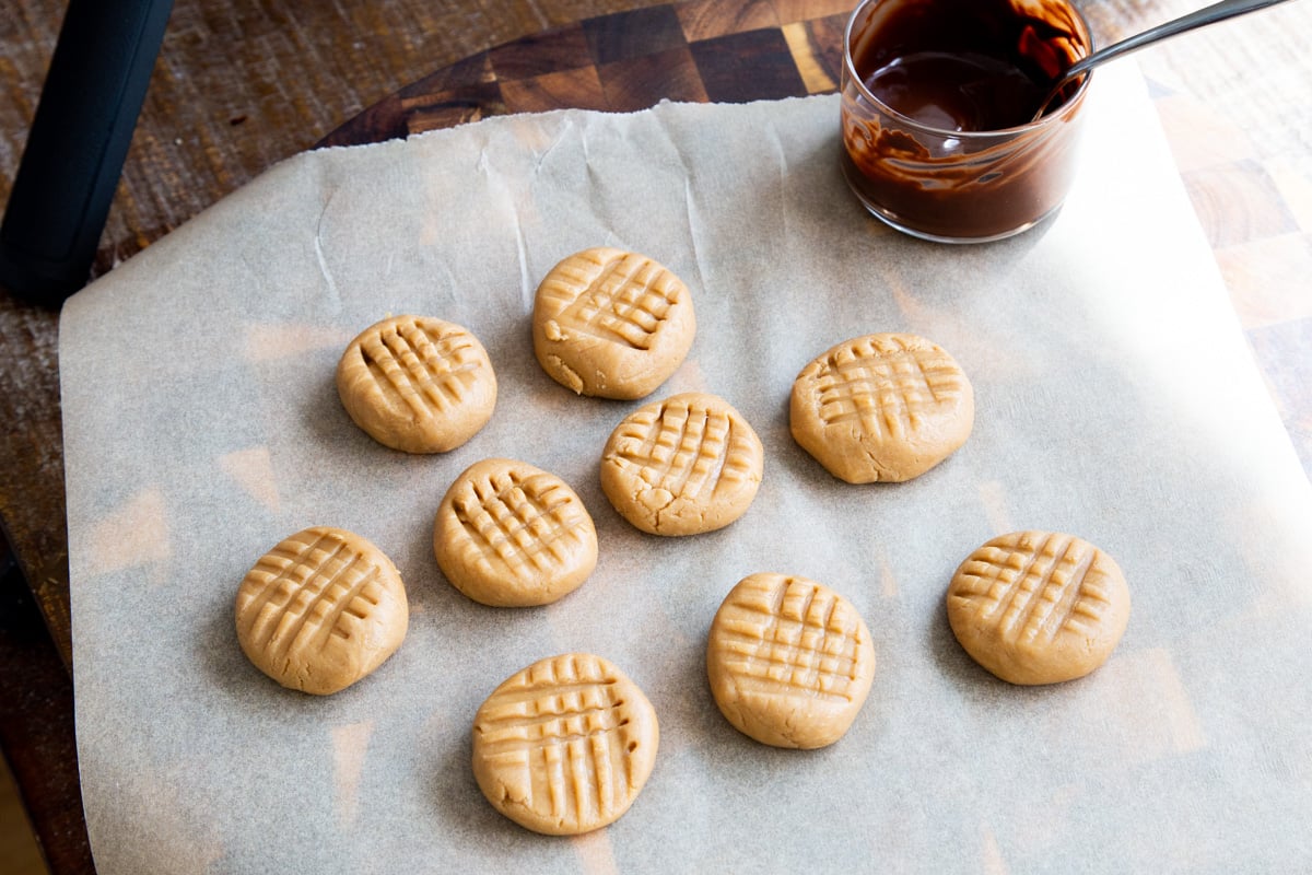 no bake peanut butter cookies with a small bowl of melted chocolate on the side