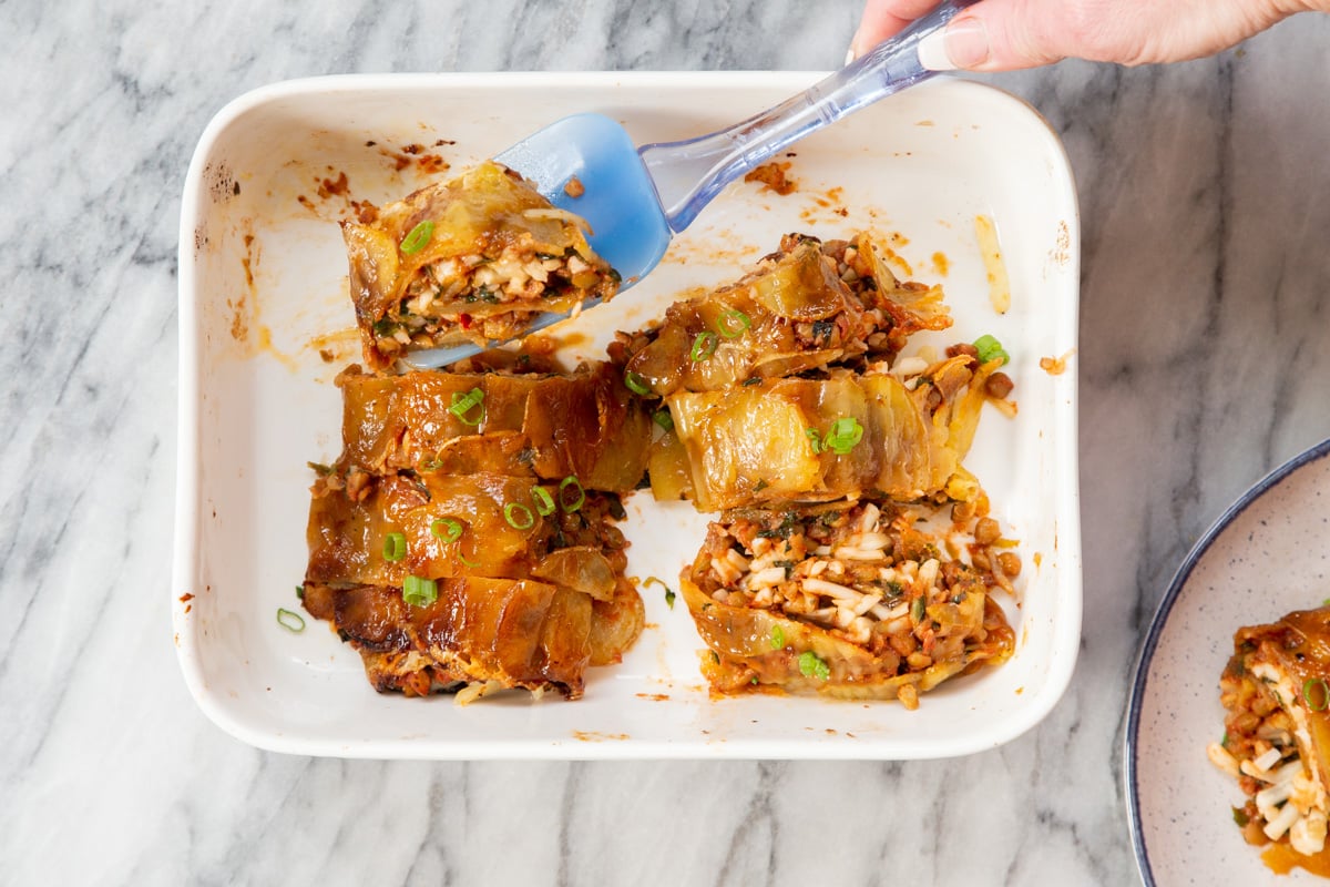 vegan scalloped potato rolls in a white casserole dish