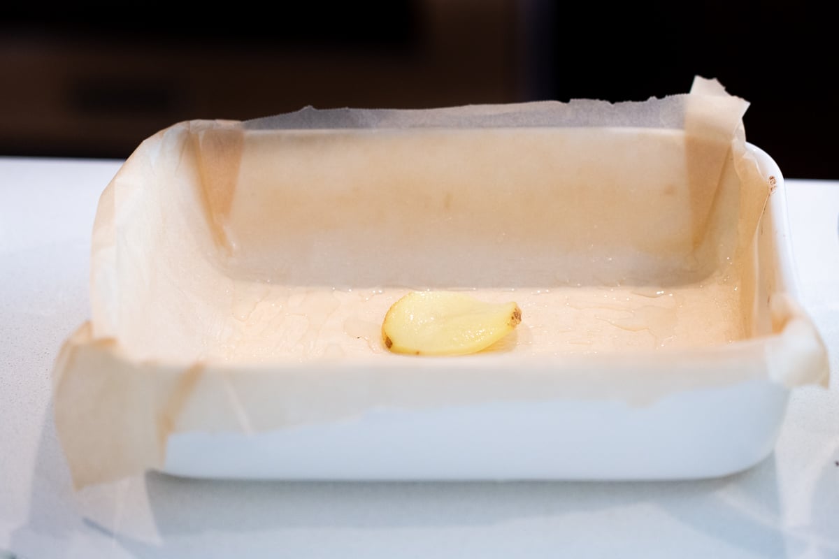 a casserole dish with a slice of potato