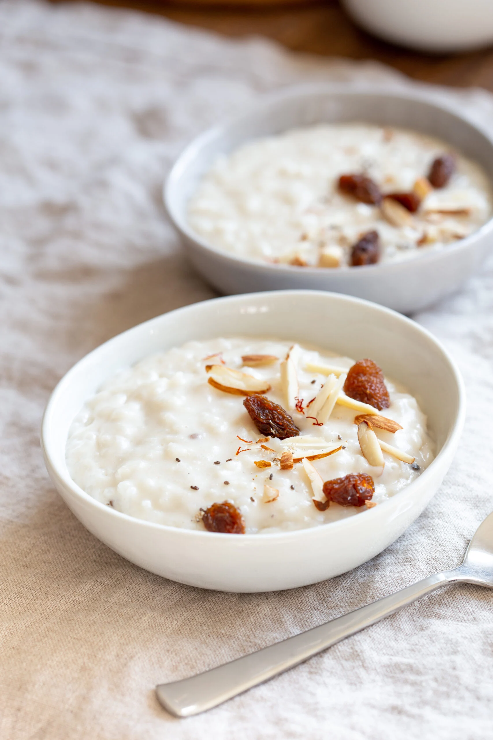two small bowls with kheer Indian rice pudding