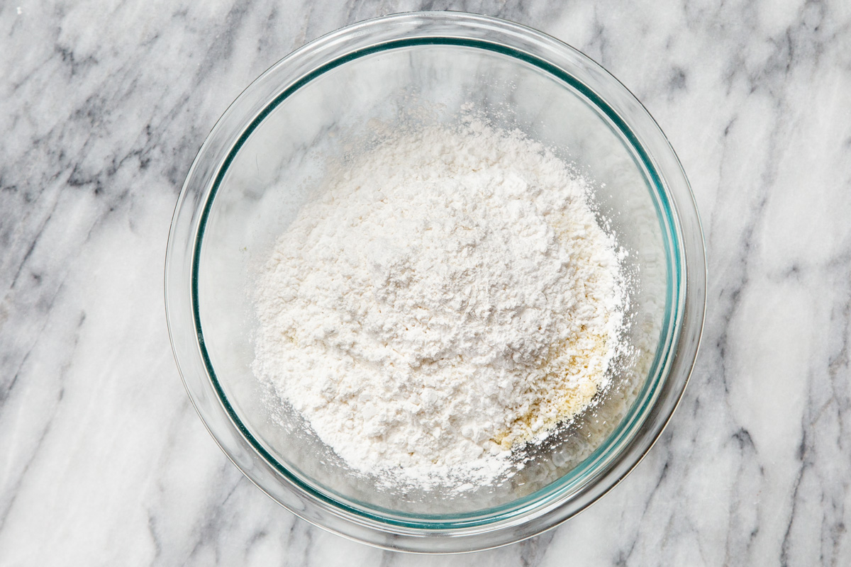 dry ingredients for making vegan almond joy cookies in a glass bowl