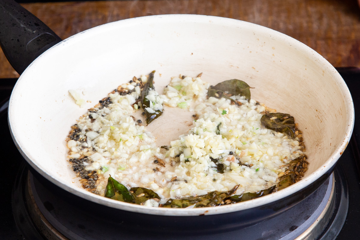 garlic and tempering in a sauteeing pan