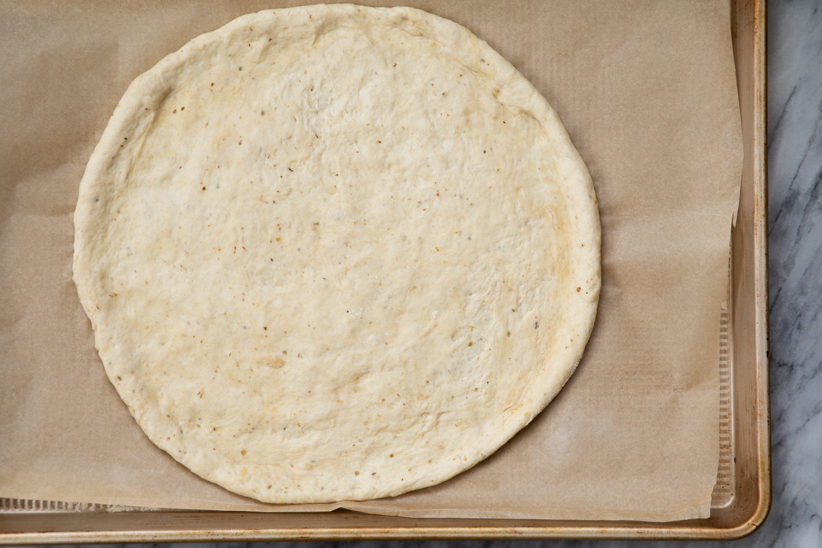 vegan pizza dough on a baking sheet