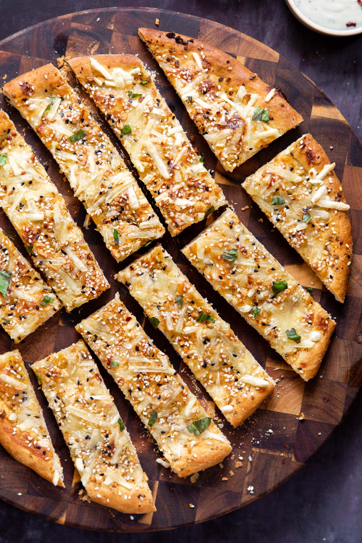 vegan everything bagel garlic cheese breadsticks on a wooden board